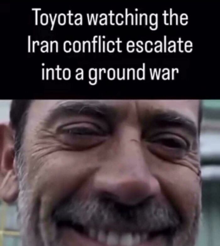 Meme about Toyota watching Iran conflict escalate into a ground war with man's smiling face