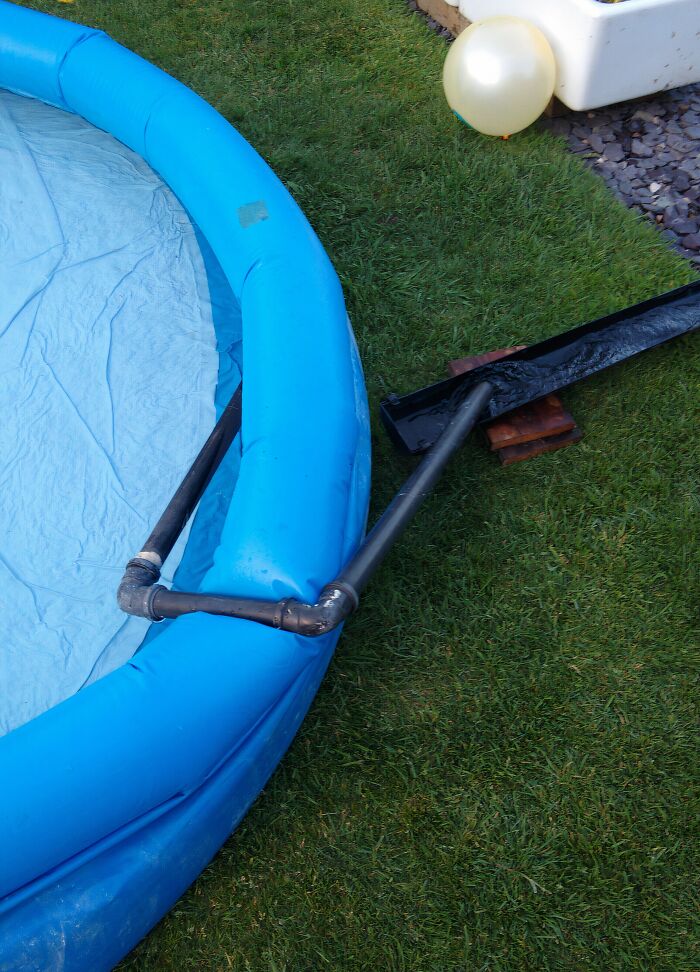 Homemade pool water drainage system using PVC pipes and pool edge