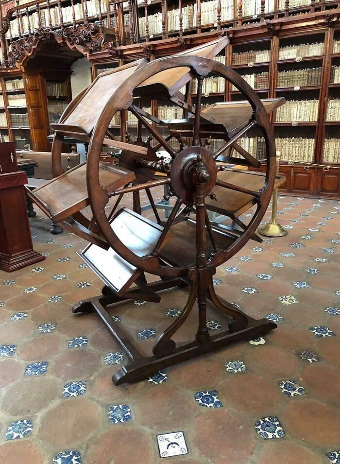 Antique wooden rotating book carousel in historic library low-tech solution