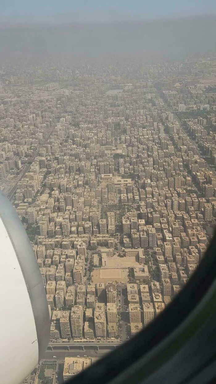 Aerial view of densely packed urban hell buildings under haze