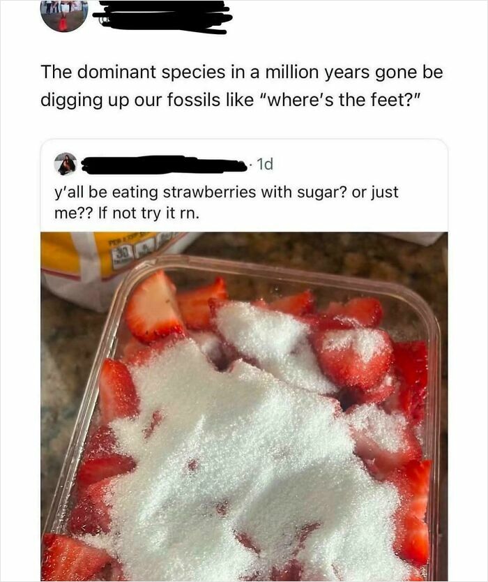 Container of sliced strawberries covered with a thick layer of granulated sugar