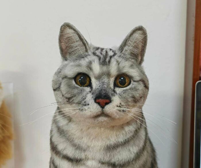 A strikingly realistic handmade felt cat, showcasing incredible talent and patience in handmade projects.