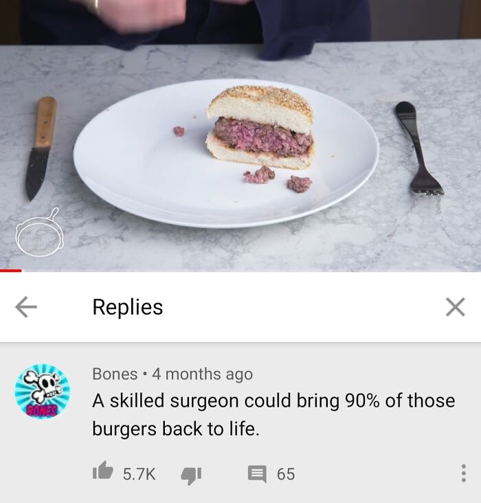 Half-eaten rare burger patty on white bread on kitchen counter