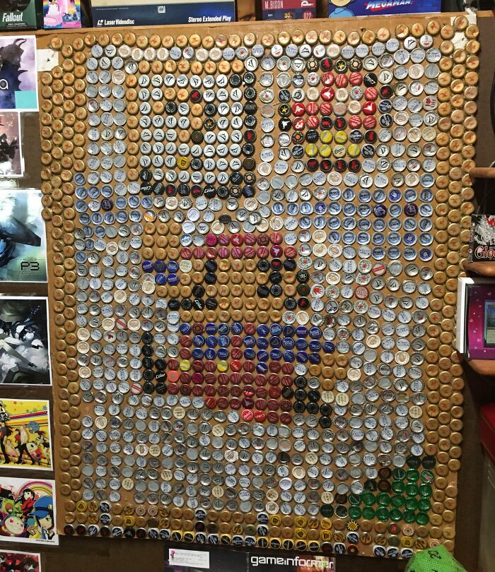 Mosaic artwork made from beer bottle caps depicting a pixelated character