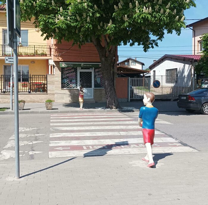 Street scene with statues at crosswalk as creative safety improvement