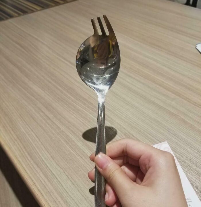 Hand holding spork utensil combining spoon and fork with main SEO keyword improved everyday things