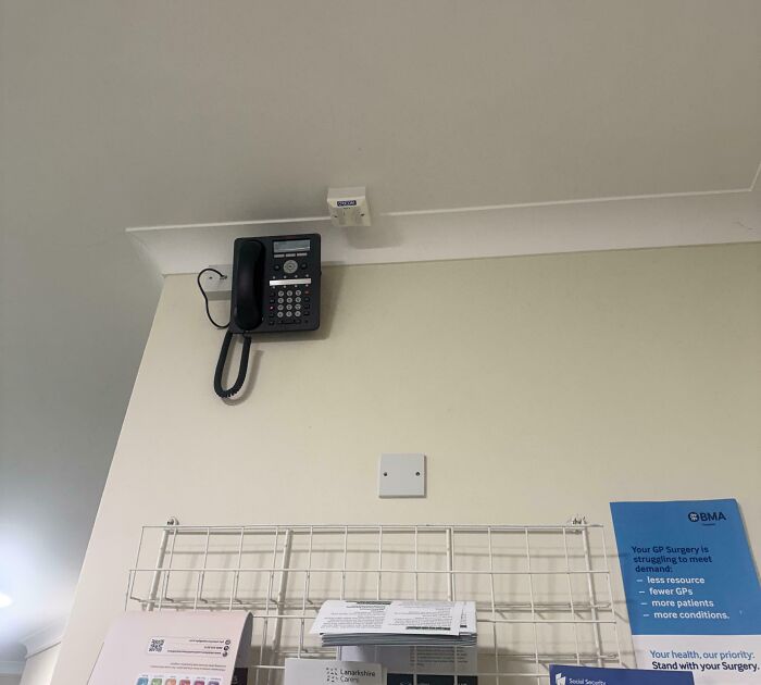 Wall-mounted telephone above papers with main SEO keyword improved everyday things