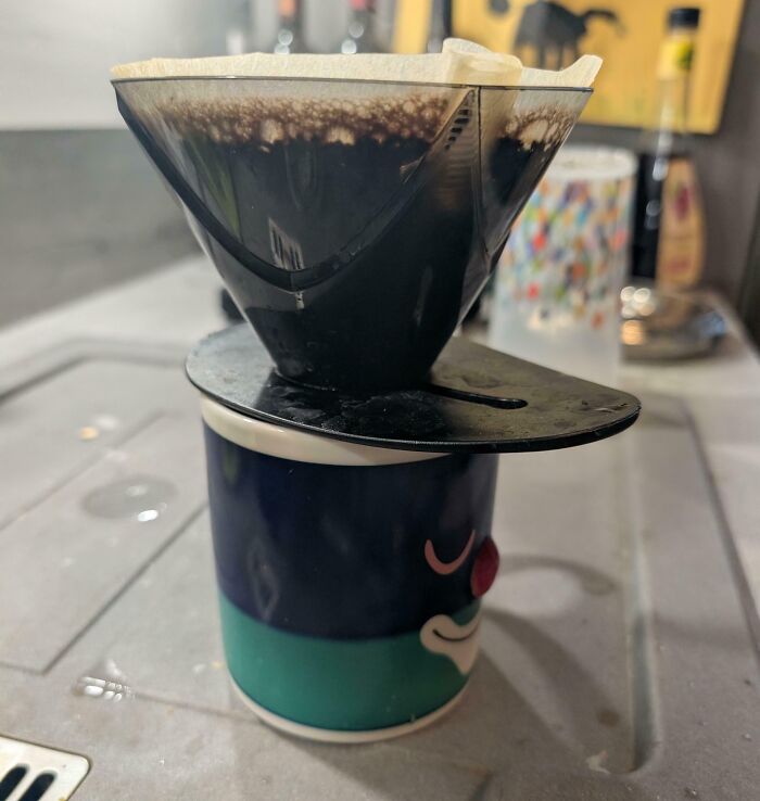 Coffee filter dripping brew into a cup with main SEO keyword improved everyday things