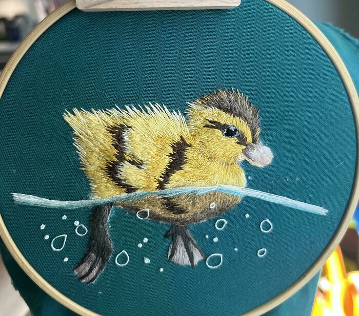 Embroidery projects featuring a detailed duckling swimming in water
