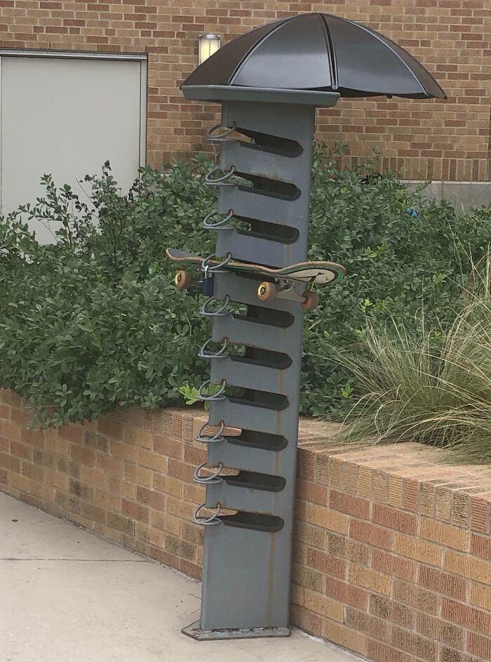 Skateboard rack with umbrella roof on university campus