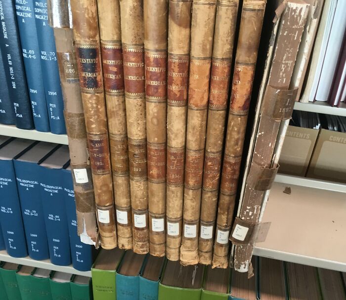Old volumes of Scientific American bound in leather on library shelf