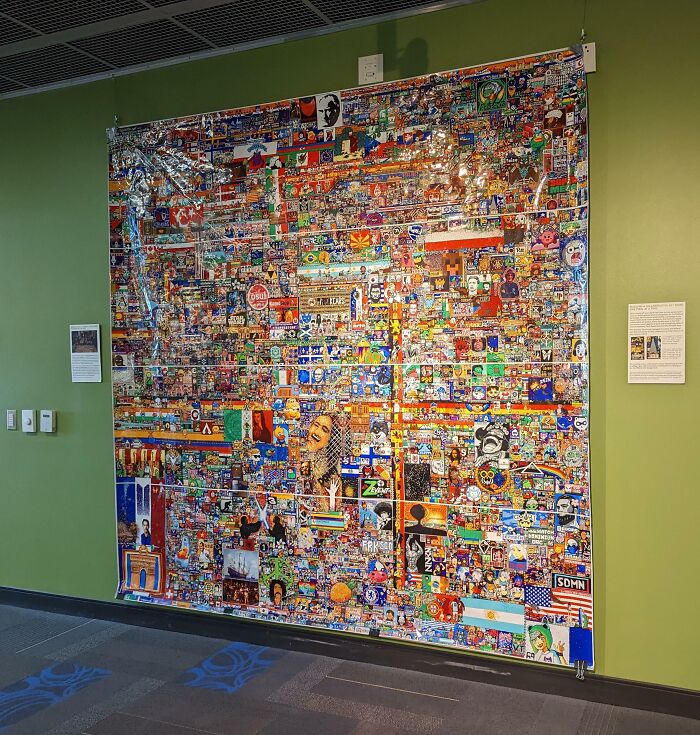 Large colorful mosaic artwork displayed on school green wall