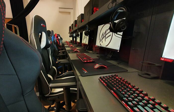 Row of gaming computers and chairs in a school's esports lab