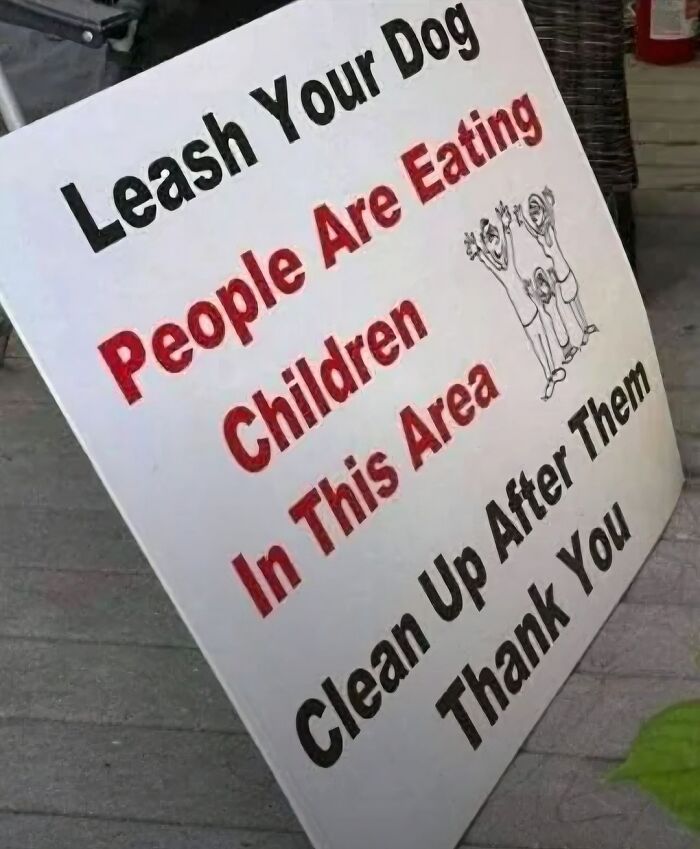 Absurd sign warning people are eating children and asking to leash dogs and clean up after them