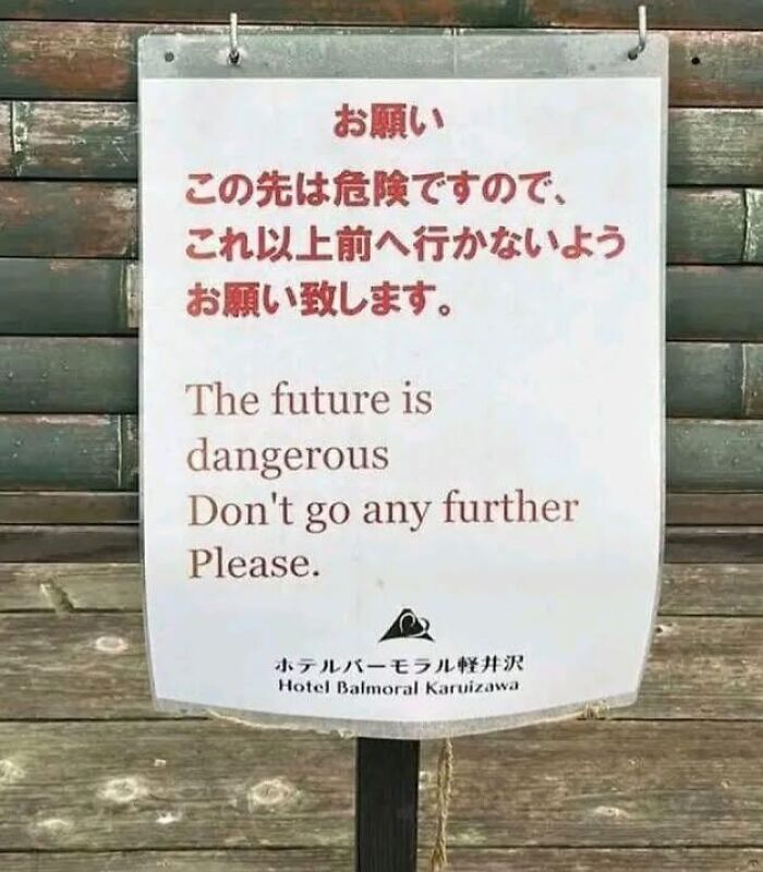 Quirky warning sign saying the future is dangerous and don't go further
