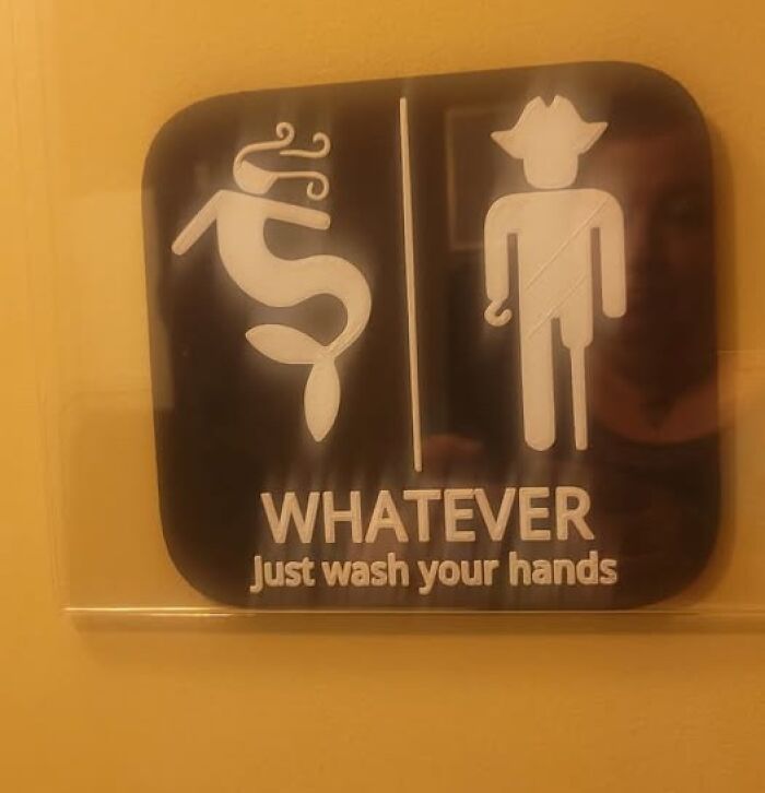 Absurd restroom sign with mermaid and cowboy icons saying just wash your hands