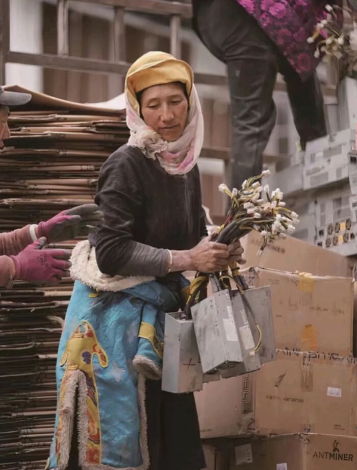 A Tibetan Woman Holding A Power Supply For A Bitcoin Mining Machine
