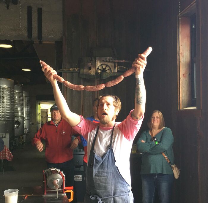 Guy Holding String Of Sausages