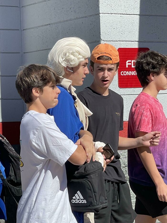 Group of boys with one dressed in historical costume