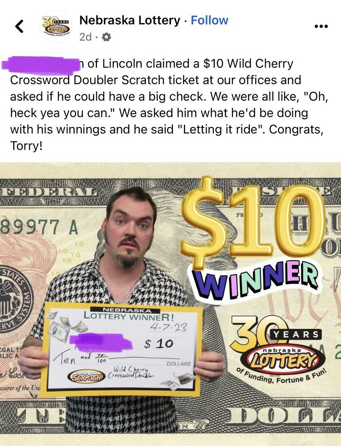 Nebraska Lottery winner holding $10 Wild Cherry Crossword Doubler check with lottery branding