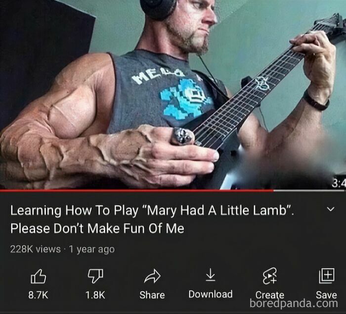 Muscular man learning to play Mary Had A Little Lamb on guitar