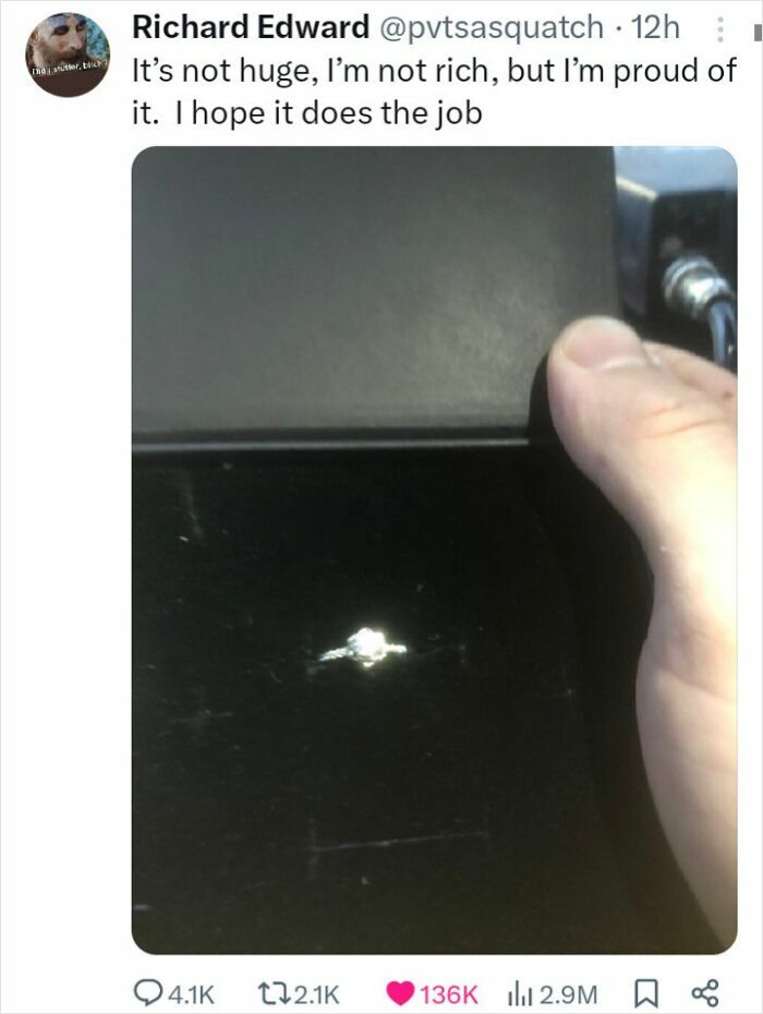 Small engagement ring in black box with message of pride and hope