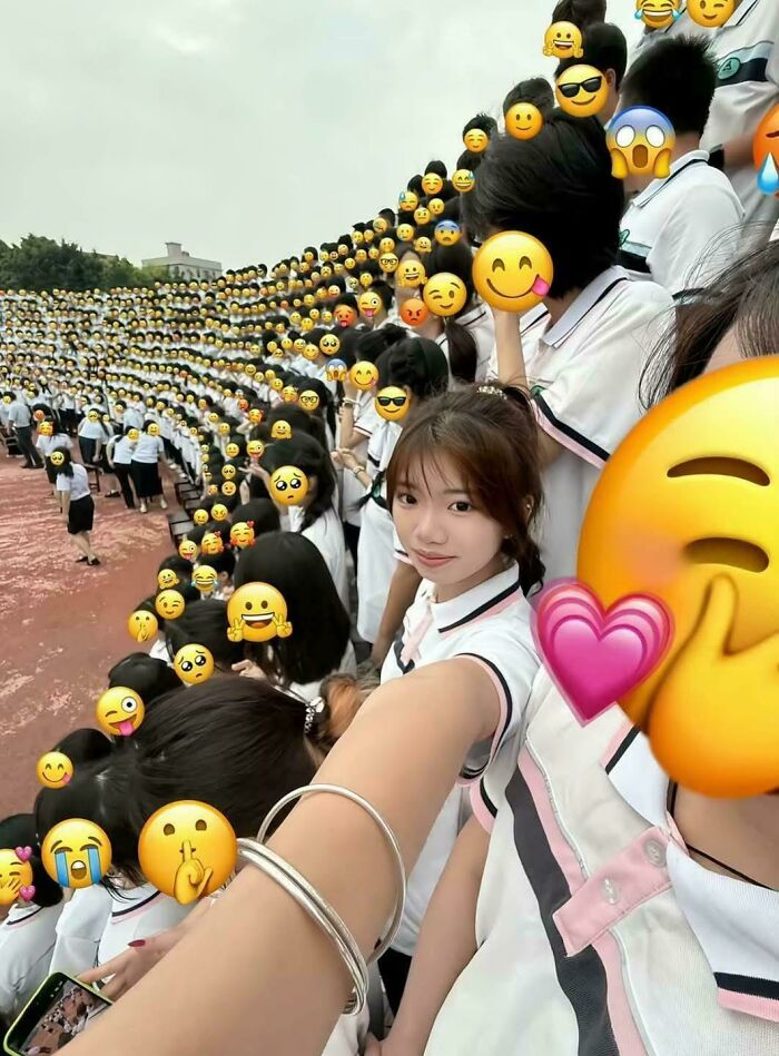 Interesting posts: A large crowd of students with emoji faces, one girl smiling at the camera for a selfie.
