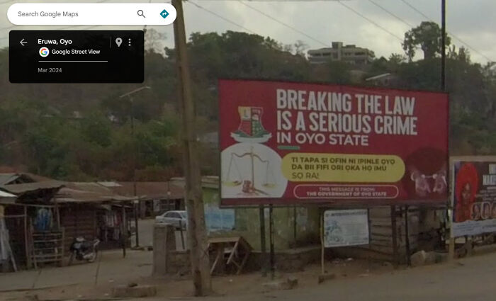 Google Street View showing a billboard warning about law-breaking in Oyo State