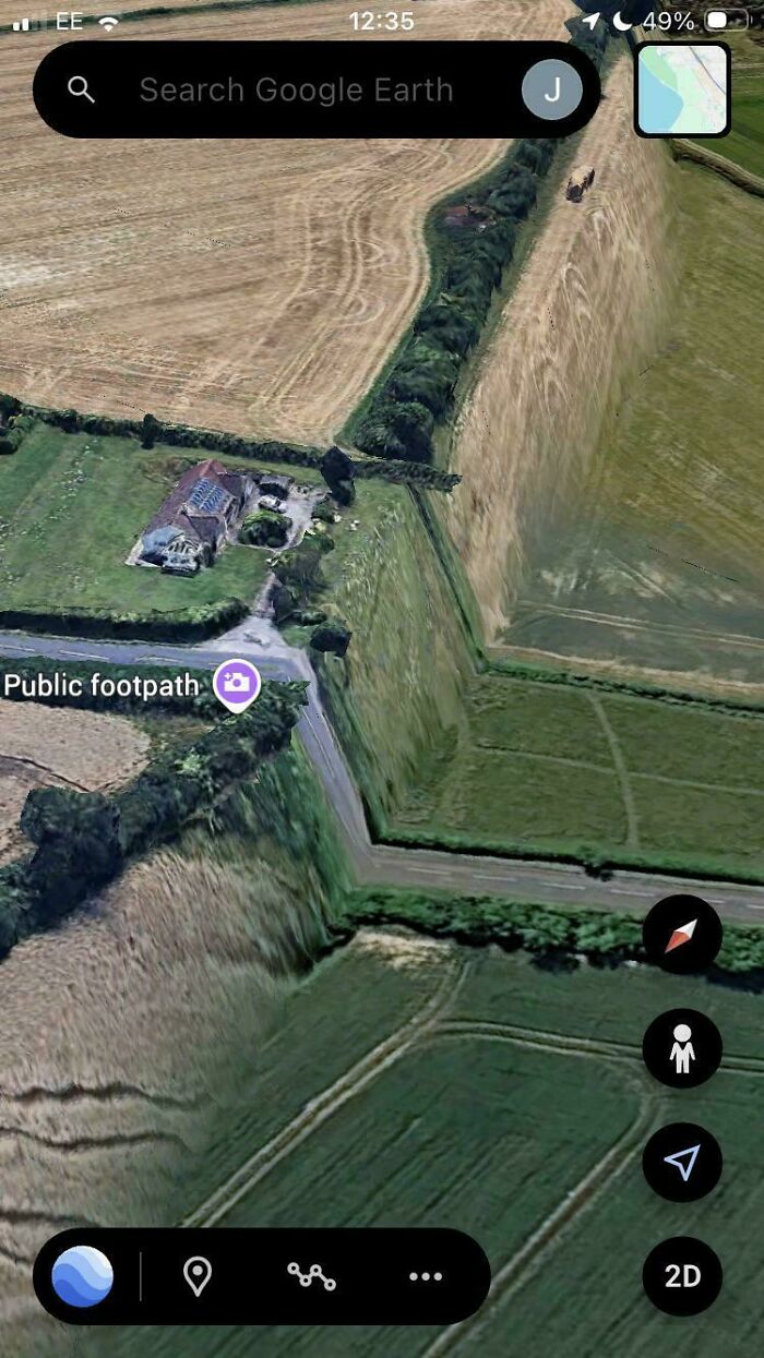 Satellite image showing a Google Maps error with a steep cliff along a rural public footpath