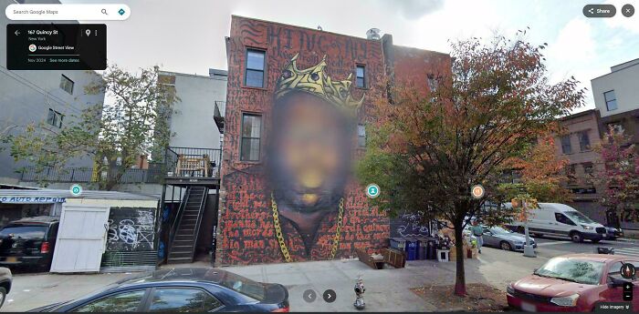 Mural of a crowned figure blurred on a building in Google Maps shenanigans