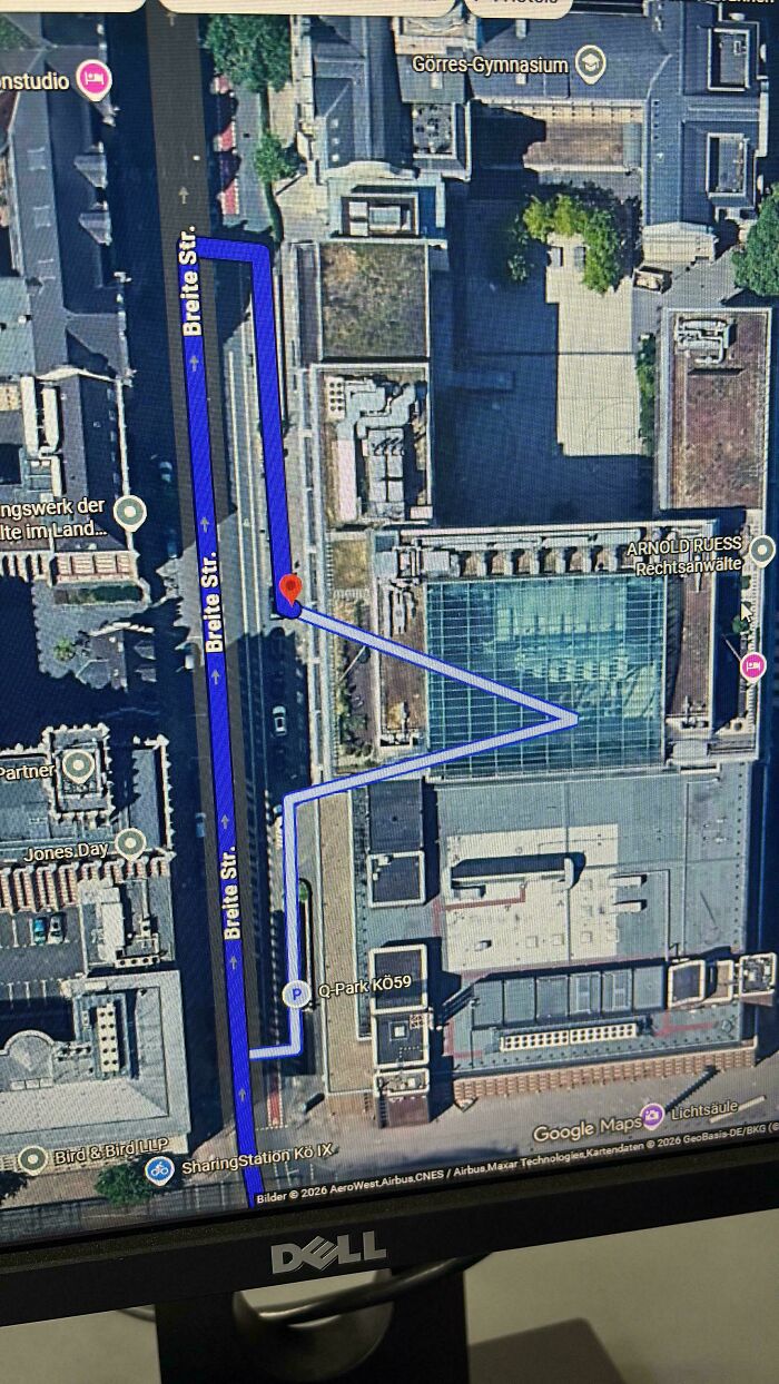 Google Maps satellite view displaying navigation route on Breite Str street