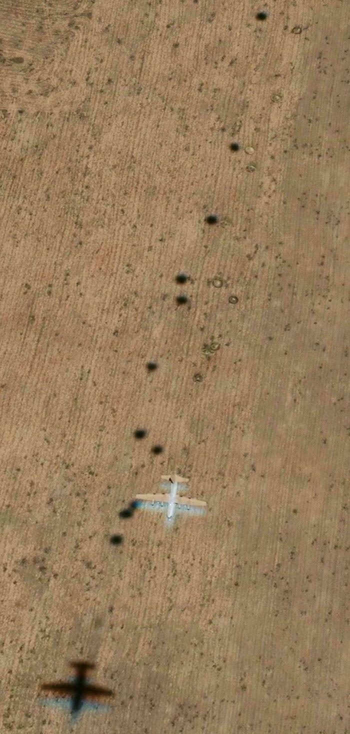 Google Maps aerial view of a plane casting multiple shadows on a field