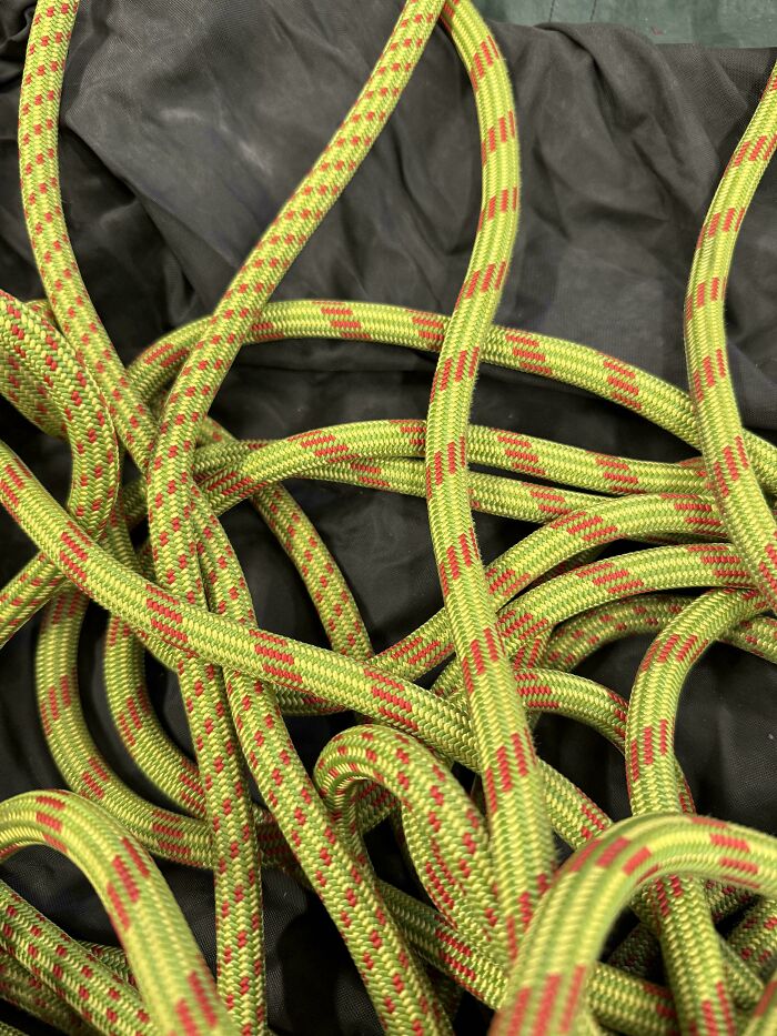 Close-up of tangled climbing rope on black fabric background