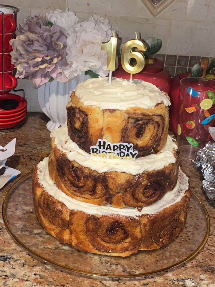 Delicious treats by bakers: A three-tiered cinnamon roll cake with candles, a sweet birthday treat.