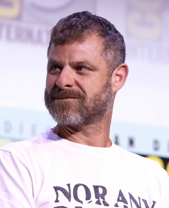Close-up of Matt Stone with beard wearing white shirt at public event