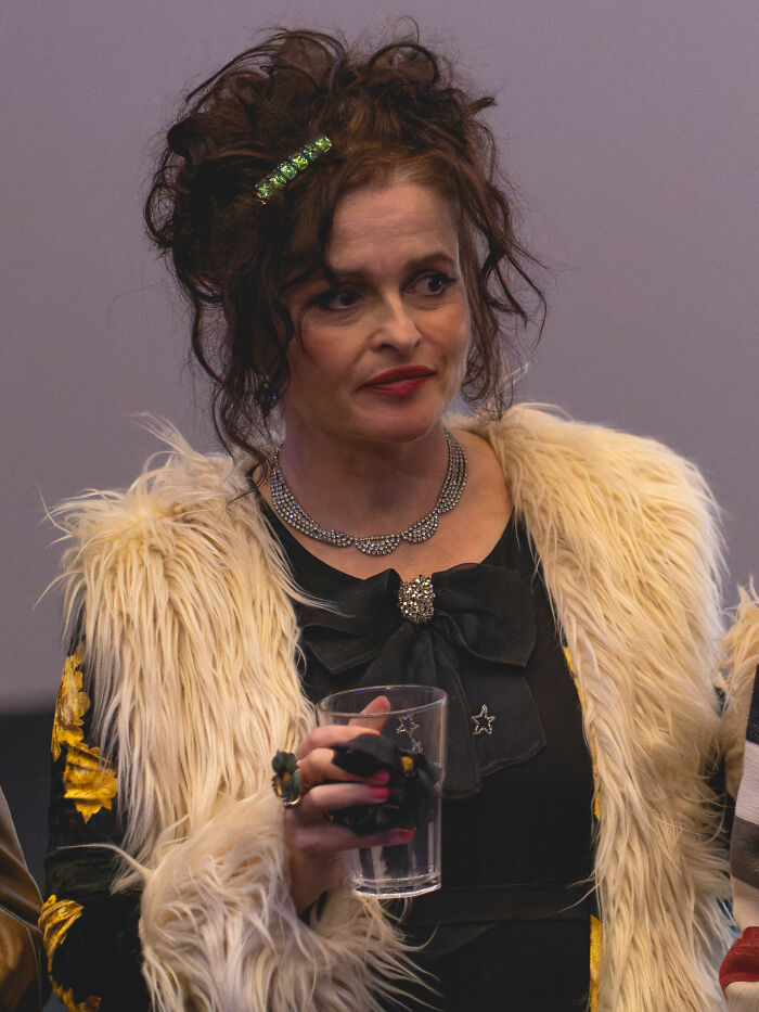 Portrait of Helena Bonham Carter wearing a fur coat and holding a glass