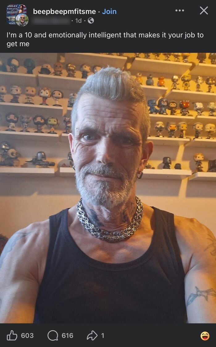 Man with tattoos and chain necklace posing in front of shelves full of collectible figurines