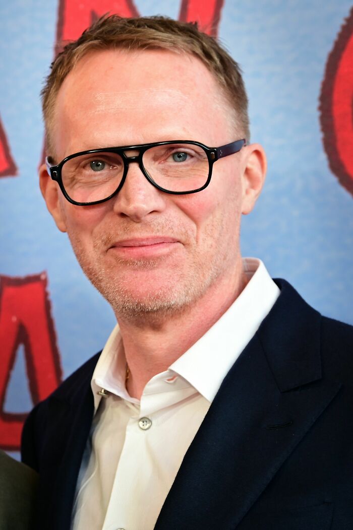 Close-up of Paul Bettany wearing glasses and a suit jacket at a public event