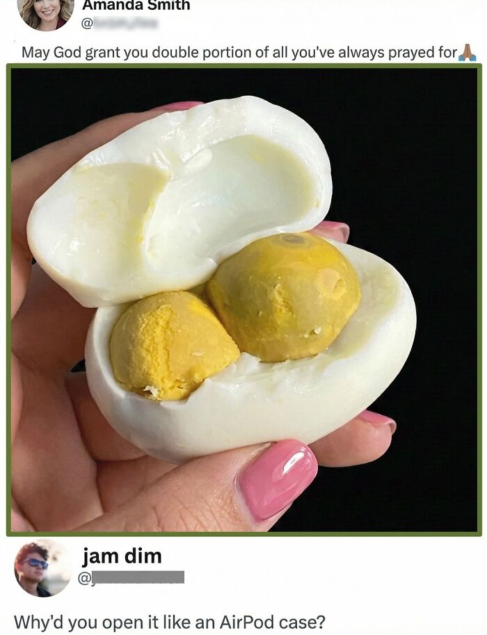 Hand holding a uniquely opened boiled egg with two yolks