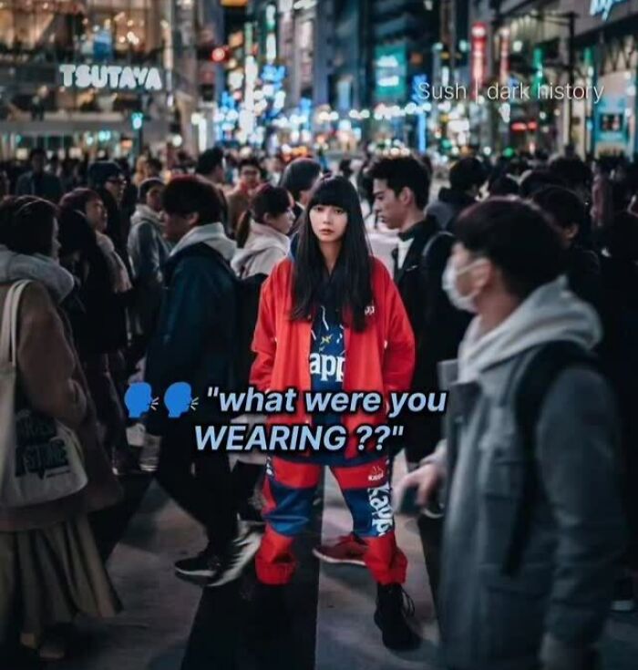 Crowded nighttime city street with a woman in red and text about what were you wearing