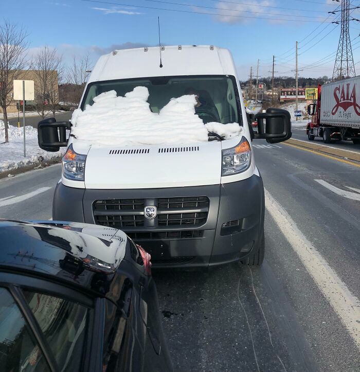 Van with snow obstructing windshield creating risky driving survival hazard