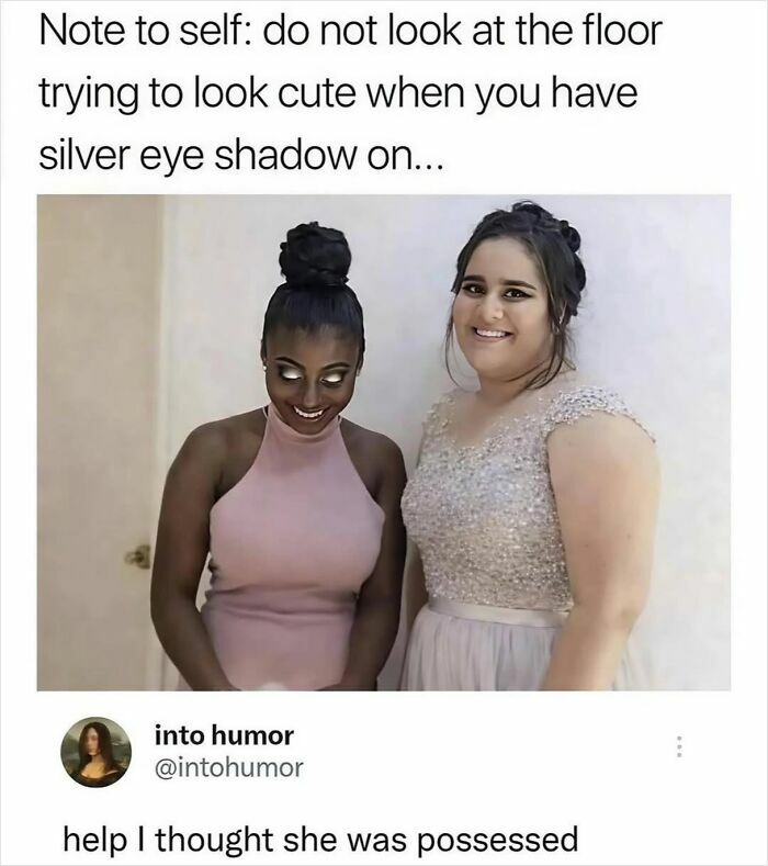 Two women smiling with one wearing silver eye shadow looking downward