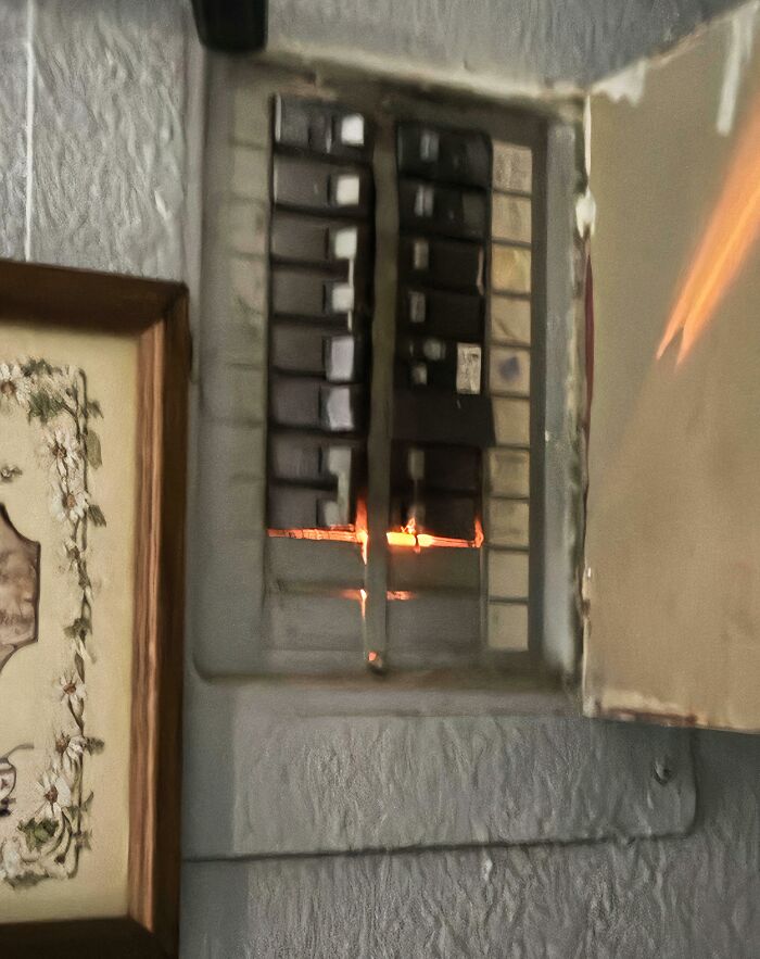 Electrical panel sparking inside fuse box indicating risk of fire