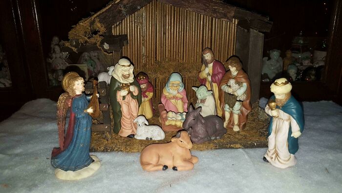 Nativity scene with figurines including Yoda placed among traditional characters