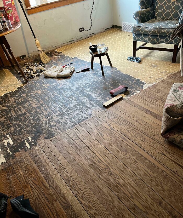 Room with partially removed flooring revealing dangerous subfloor condition