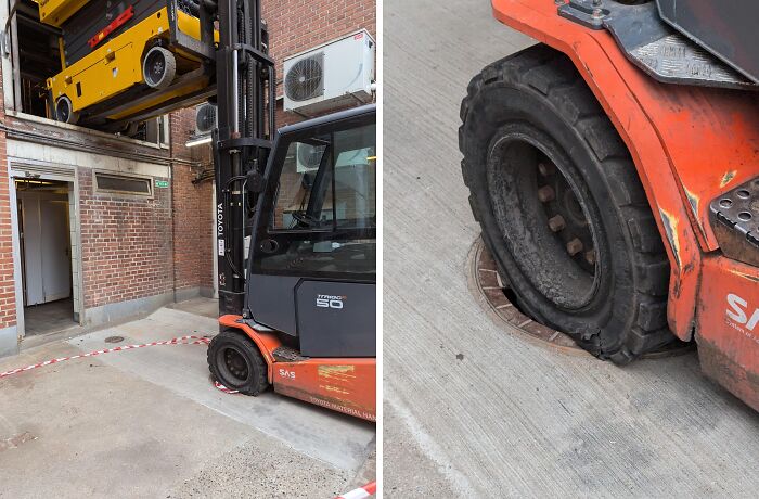 Forklift with flat tire stuck in a pit near warehouse entrance