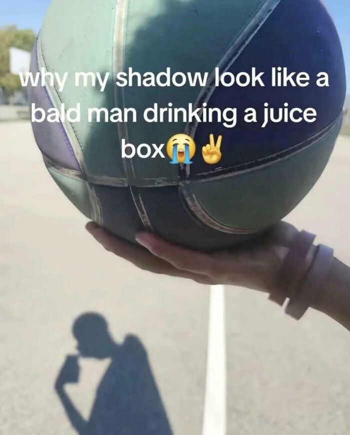 Basketball shadow looks like bald man drinking juice box humorous