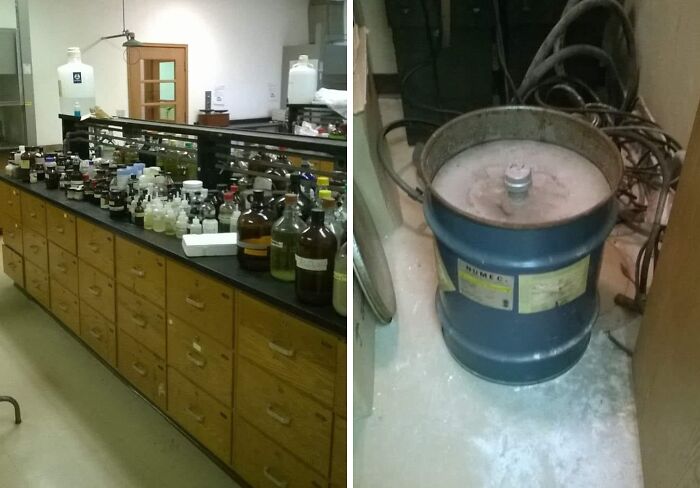 Cluster of chemical bottles on counter and a metal drum in a lab area