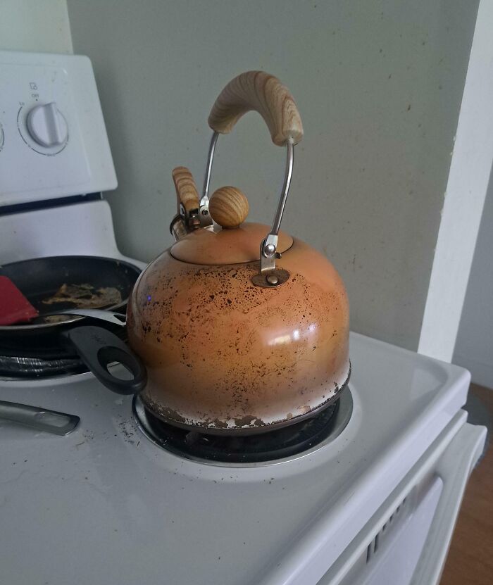 Rusty and stained kettle on stove showing risky survival situation hazards