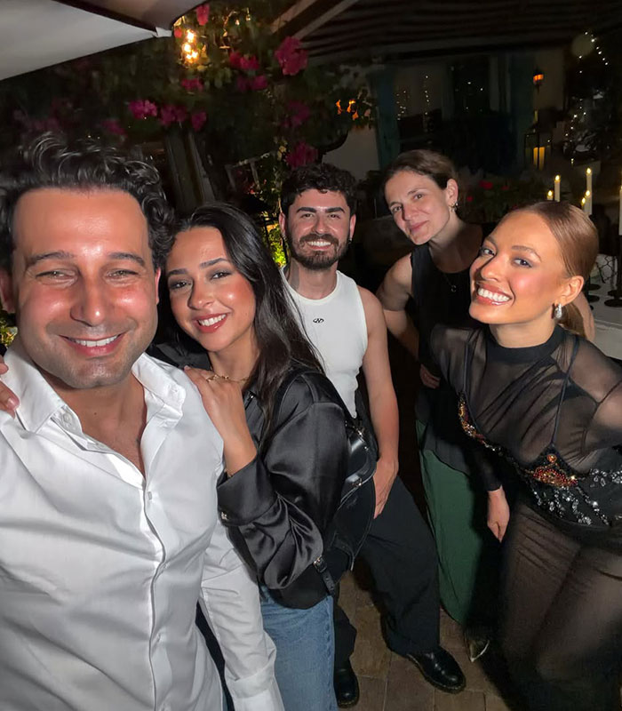 Group smiling at party related to TV star Miami restaurant event